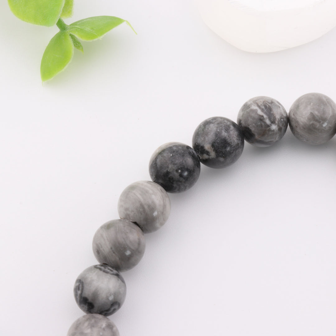 Pulsera de jaspe gris natural con detalle de cabeza de Buda dorada - Cuentas de 8 mm - Joyería de cristal curativo