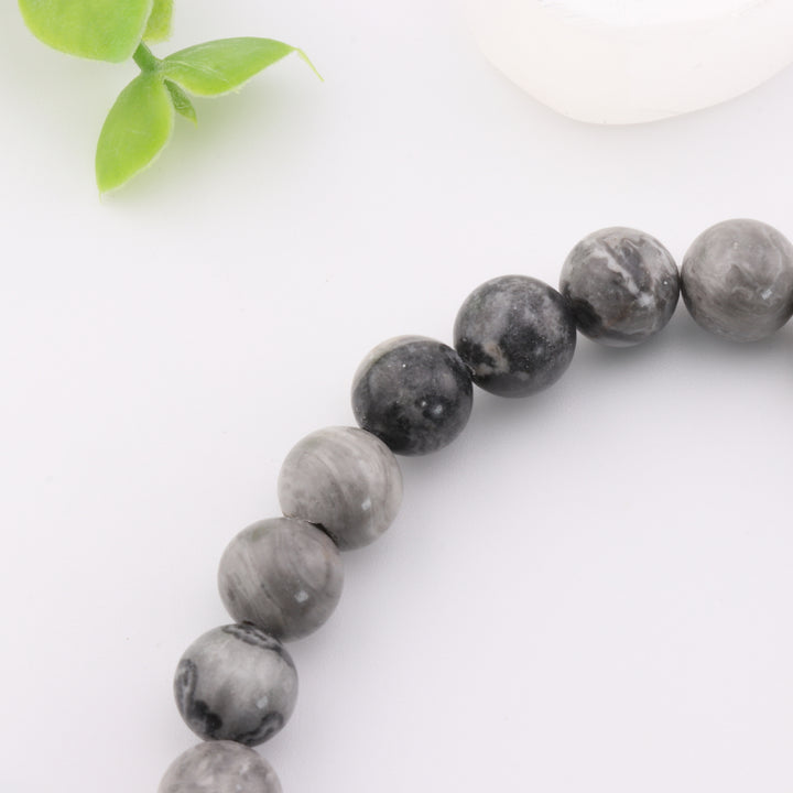 Pulsera de jaspe gris natural con detalle de cabeza de Buda dorada - Cuentas de 8 mm - Joyería de cristal curativo