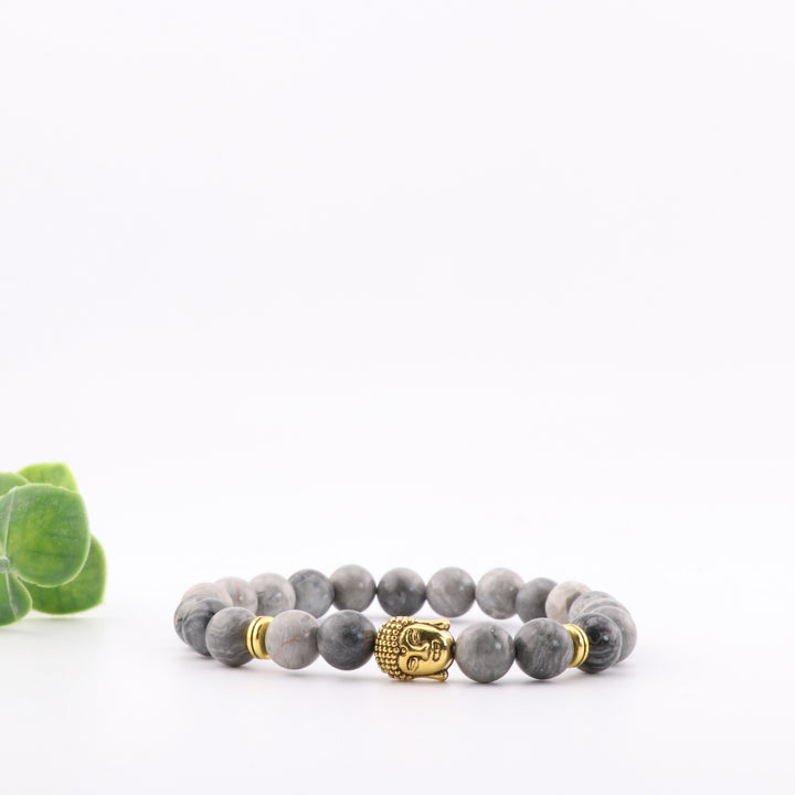 Pulsera de jaspe gris natural con detalle de cabeza de Buda dorada - Cuentas de 8 mm - Joyería de cristal curativo