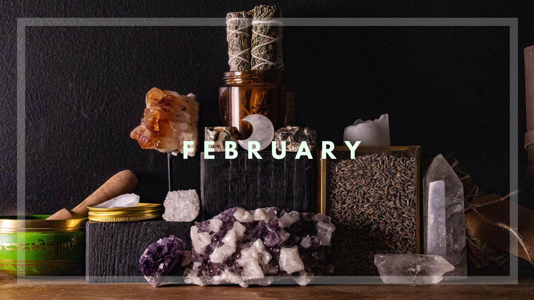 February-themed crystal altar with candles, sage, herbs, and moon decor, representing lunar phases and zodiac-inspired rituals.