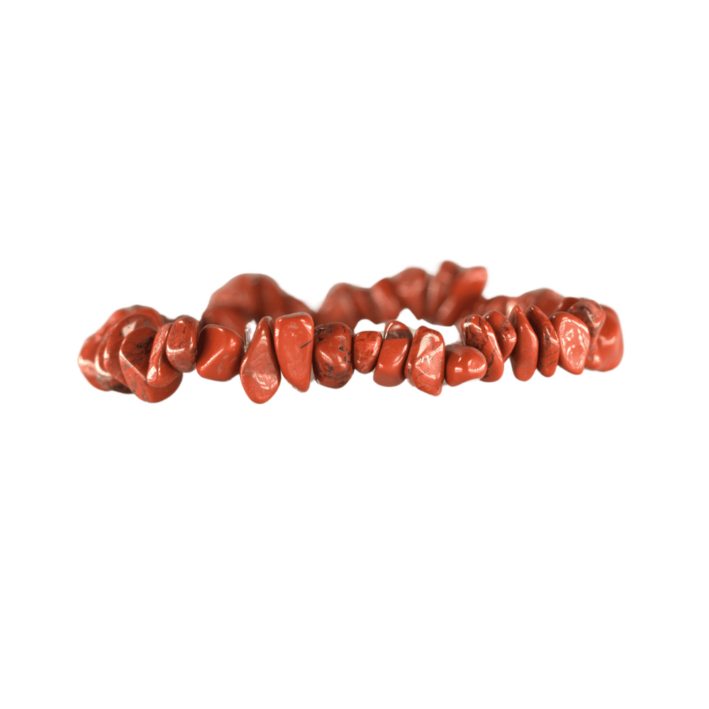 A red jasper chip bead bracelet featuring irregular tumbled stones in an earthy red hue on an elastic string
