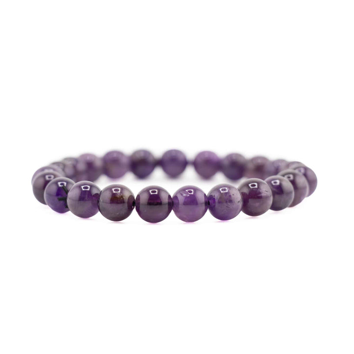 Side view resting shot of a deep purple Amethyst beaded stretch bracelet on a white background