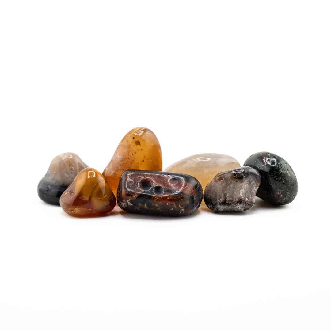 A horizontal cluster of varied polished agate tumbled stones set against a clean white background.