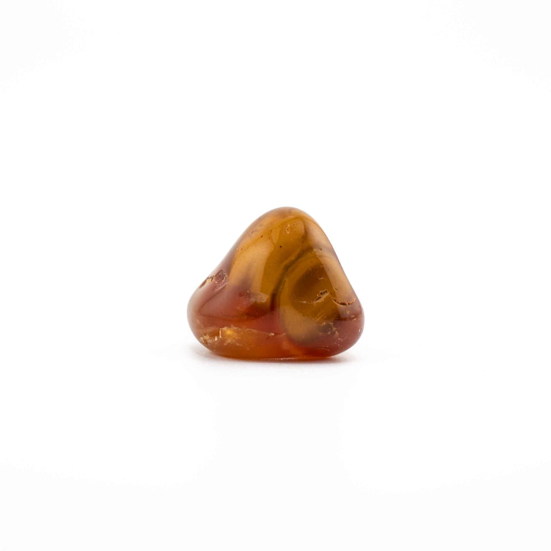 A rounded, triangular warm agate tumbled stone centered on a solid white backdrop.