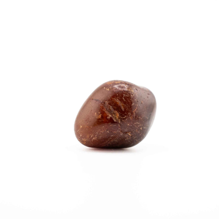 A single, oval reddish-brown agate tumbled stone displayed centrally on a solid white background.