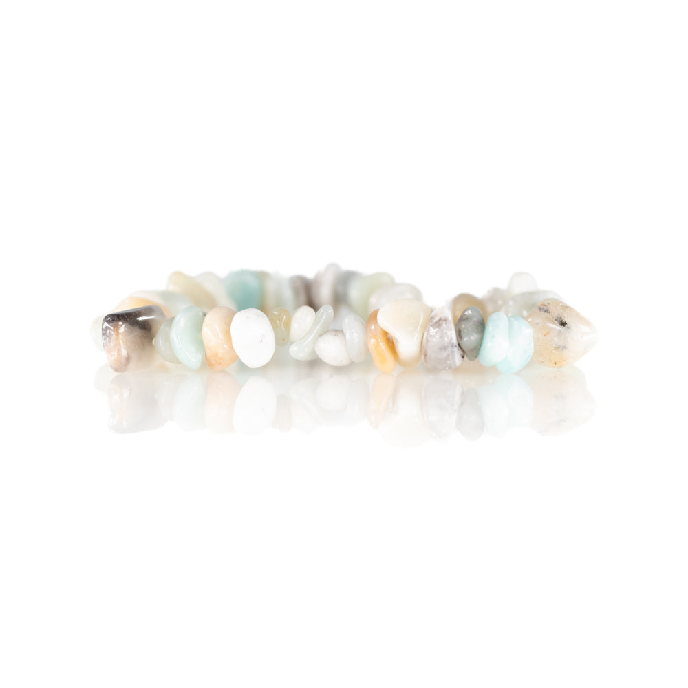 Gemstone bracelet with irregular tumbled amazonite and moonstone beads in pastel shades of light blue, white, and peach reflecting on a pristine white studio background