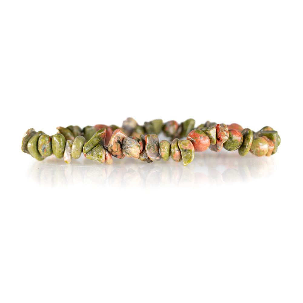 Unakite chip bead bracelet on a white reflective surface showcasing natural variations of earthy green and speckled reddish-pink polished stones