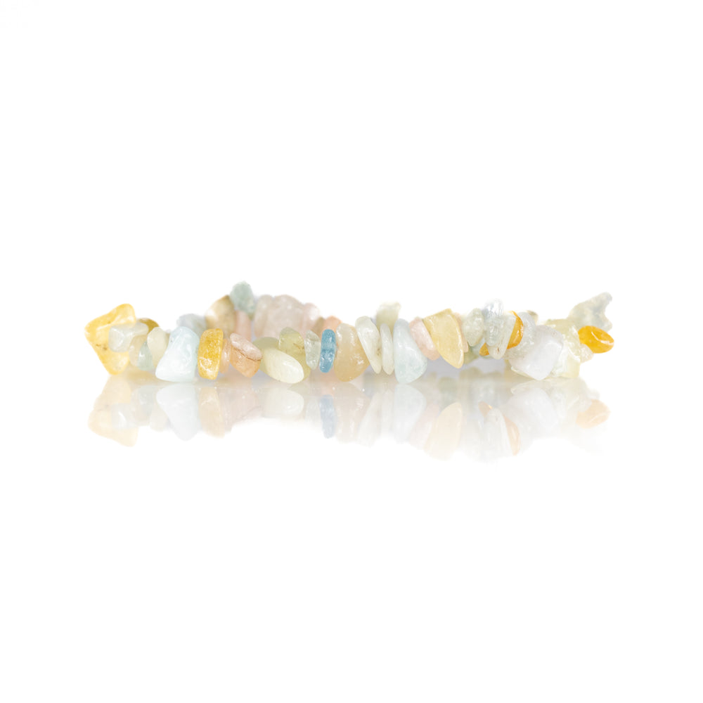Pastel gemstone chip bead bracelet featuring pale blue aquamarine, soft pink rose quartz, and light yellow citrine stones on a reflective white surface