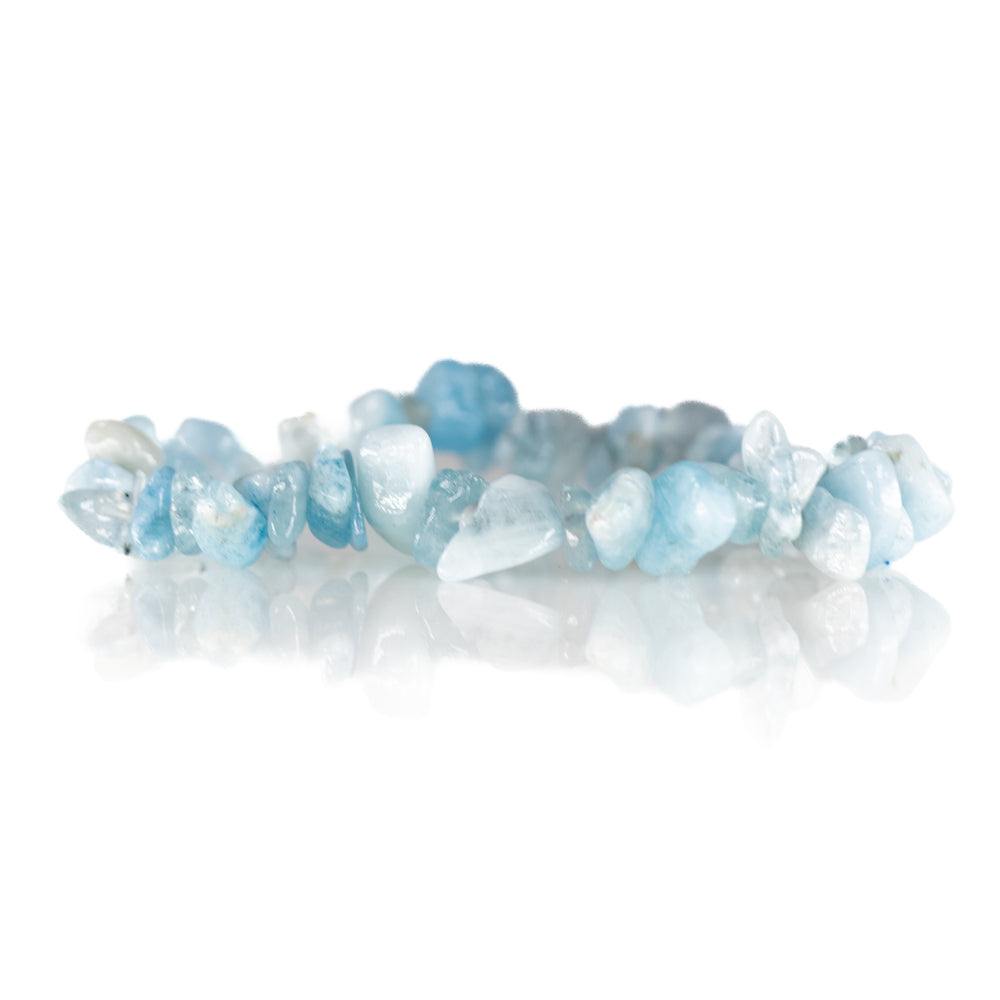 Gemstone chip bracelet featuring irregularly shaped pale blue to clear aquamarine nuggets on a delicate string, softly reflected on a pure white surface
