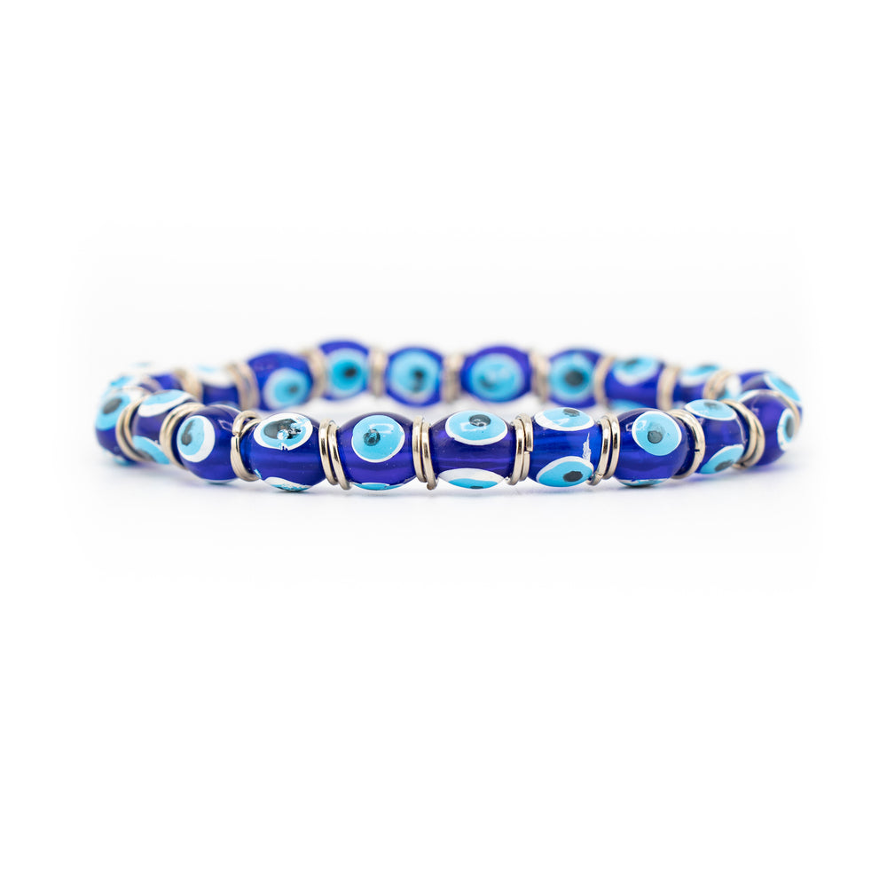 Blue evil eye bead bracelet featuring dark blue glass beads with lighter blue and white eye patterns separated by silver-toned spacers on a white background