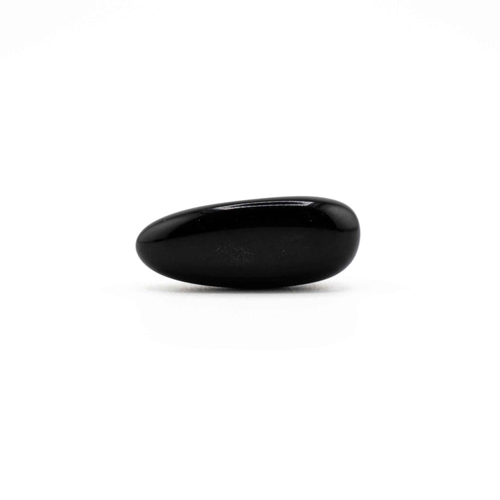 Elongated, oval-shaped Black Obsidian tumbled crystal stone resting horizontally on a white background