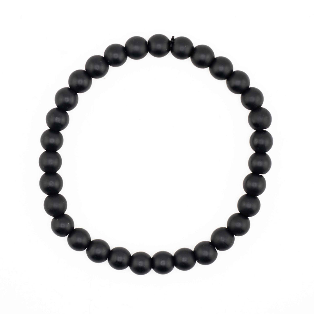 Matte Frosted Black Onyx beaded stretch bracelet featuring smooth, non-reflective round black gemstone spheres on a white background