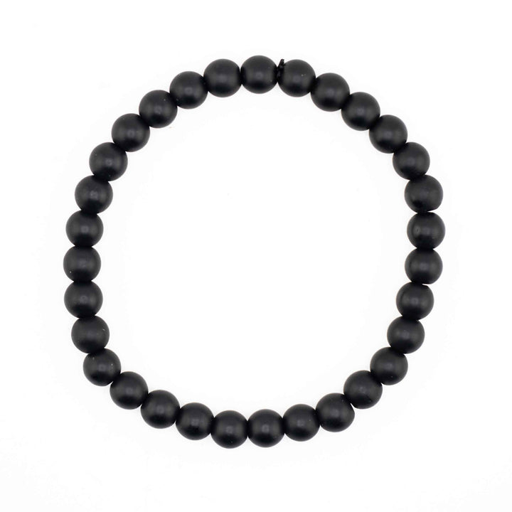 Matte Frosted Black Onyx beaded stretch bracelet featuring smooth, non-reflective round black gemstone spheres on a white background
