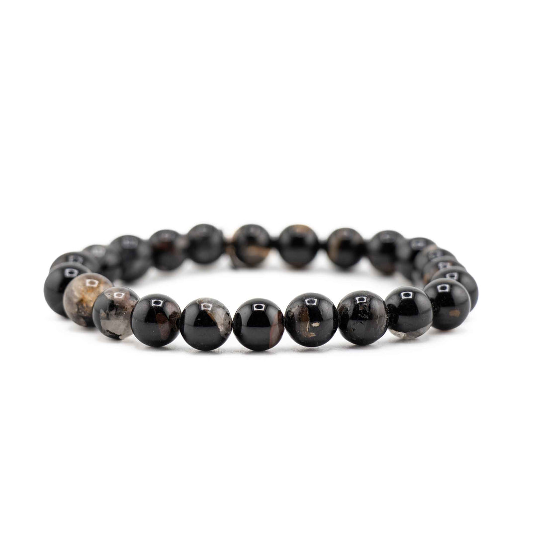 Side view resting shot of a Black Tourmaline gemstone beaded stretch bracelet resting flat on a white background