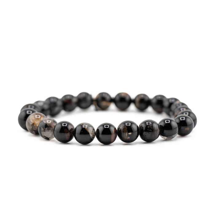 Side view resting shot of a Black Tourmaline gemstone beaded stretch bracelet resting flat on a white background