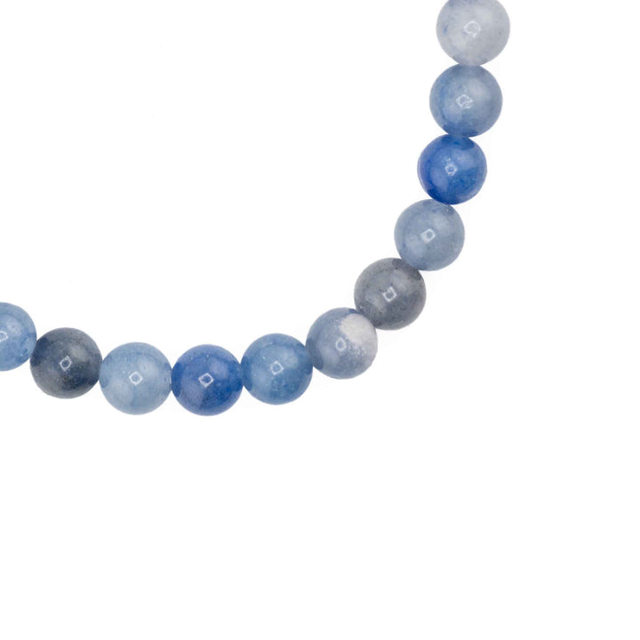 Close-up detail of smooth round Blue Aventurine beads displaying varied shades of dusty blue and subtle quartz inclusions