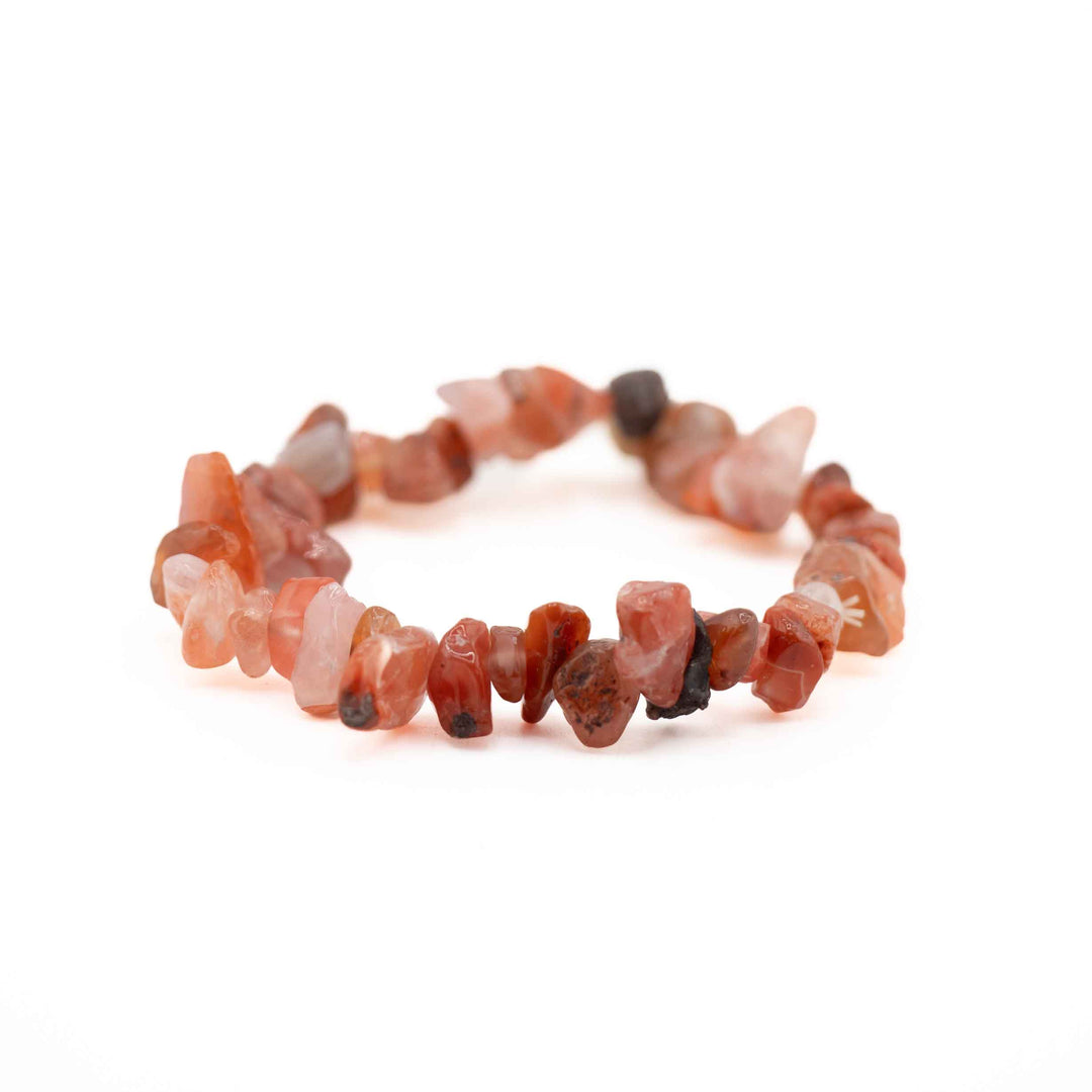 Side view resting shot of a Carnelian chip bead bracelet displaying smooth, polished gemstone chips in fiery orange and reddish-brown tones