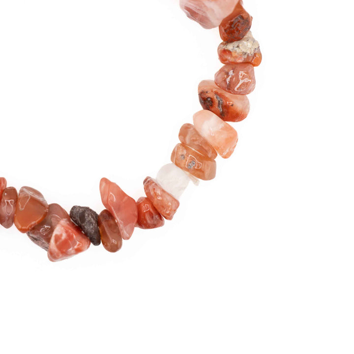 Close-up detail of natural Carnelian tumbled chips highlighting unique color variations and polished textures