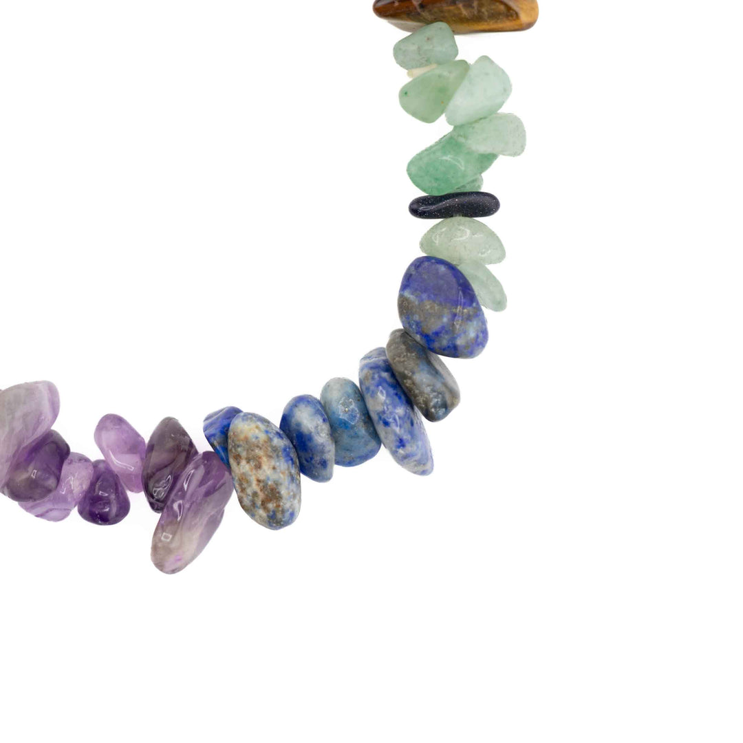 Close-up detail of natural gemstone chips on a chakra bracelet, showing green aventurine, lapis lazuli, and amethyst chips