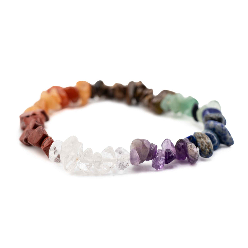 Side view resting shot displaying clear quartz and purple amethyst tumbled gemstone chips on a colorful chakra stretch bracelet