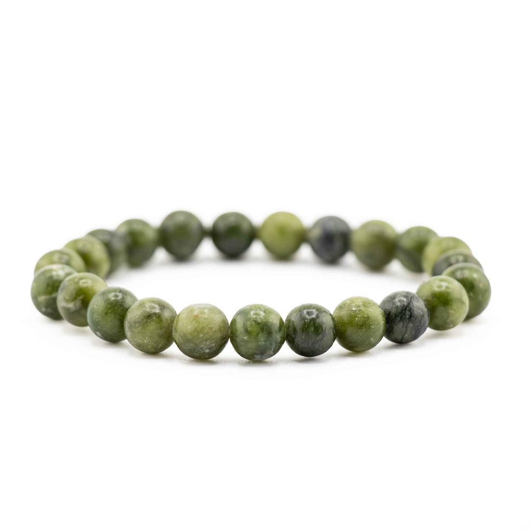 Side view resting shot of a Chinese Jade gemstone beaded bracelet on a white background
