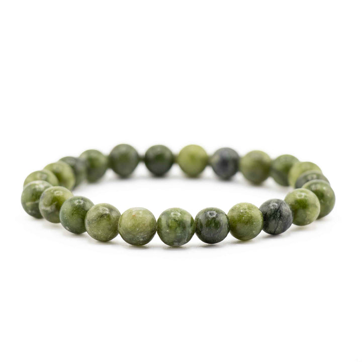 Side view resting shot of a Chinese Jade gemstone beaded bracelet on a white background