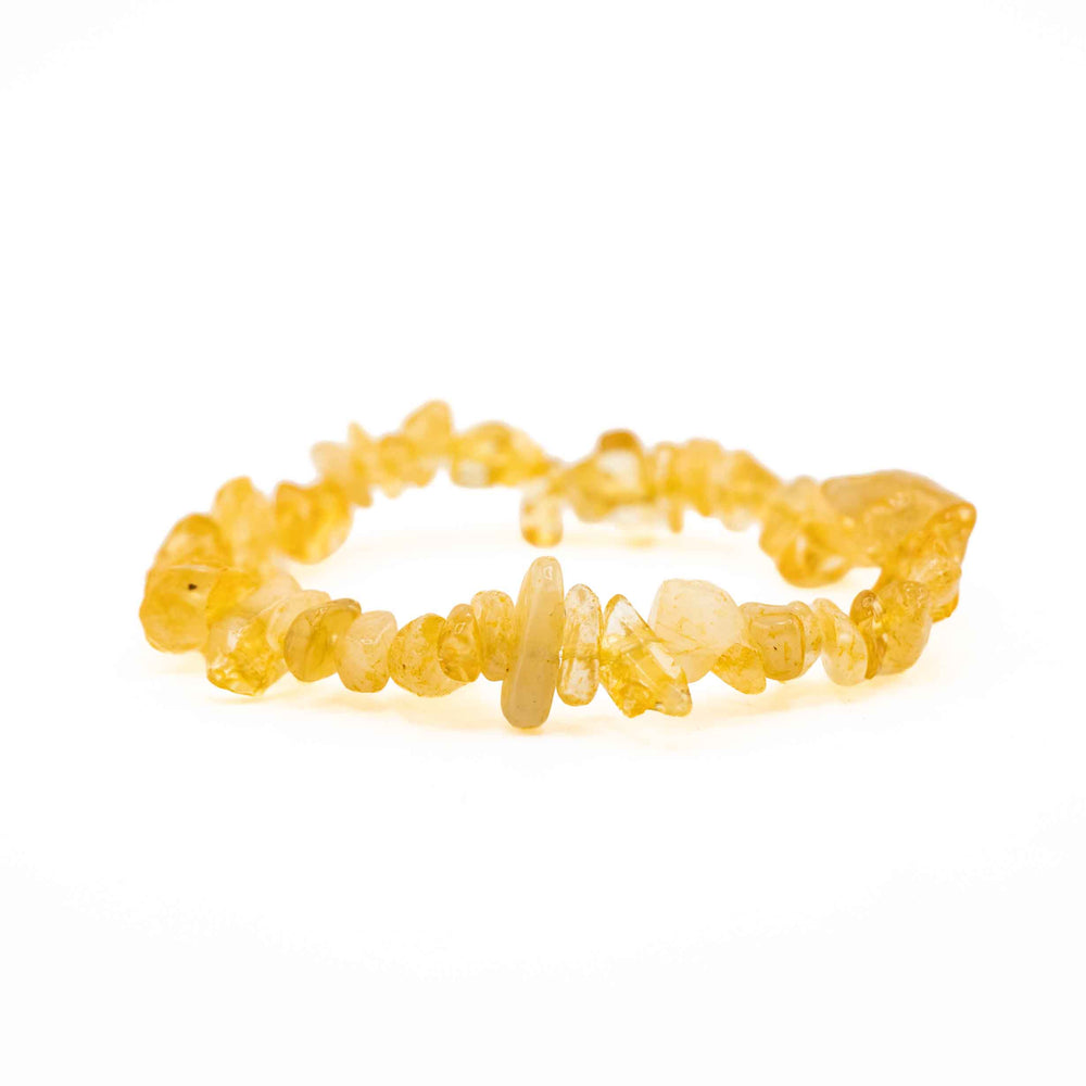 Side view resting shot of a Citrine chip stone bracelet displaying smooth, polished yellow crystal chips