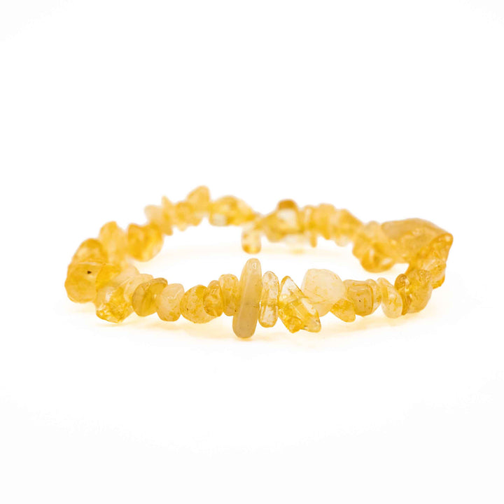 Side view resting shot of a Citrine chip stone bracelet displaying smooth, polished yellow crystal chips