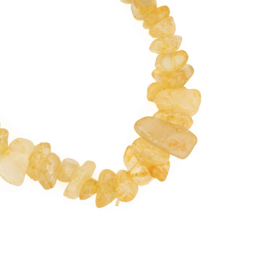 Close-up detail of natural Citrine tumbled chips highlighting sunny yellow transparency and raw crystal textures