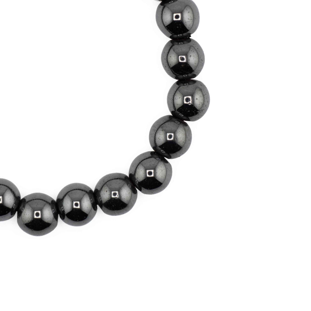 Close-up detail of glossy, round Hematite beads highlighting reflective metallic charcoal surfaces