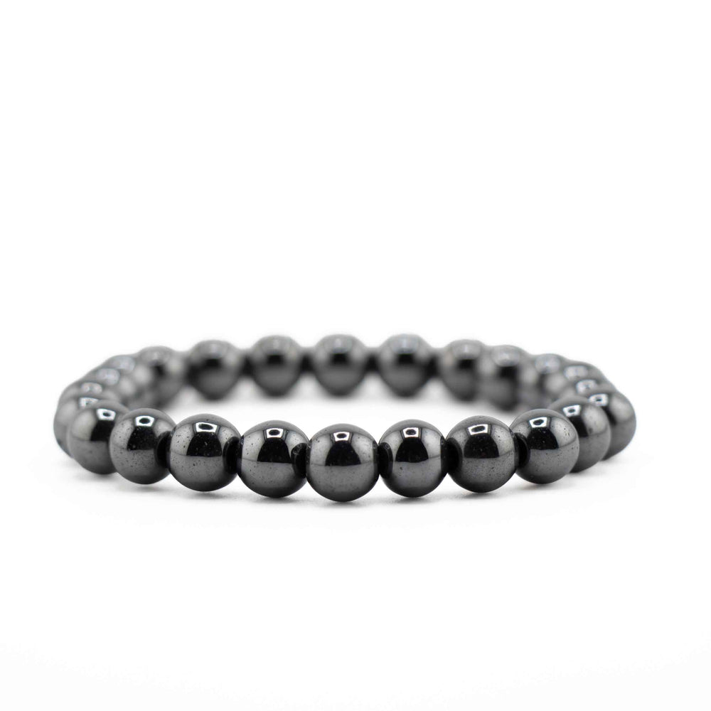 Side view resting shot of a natural Hematite gemstone beaded bracelet on a clean white background