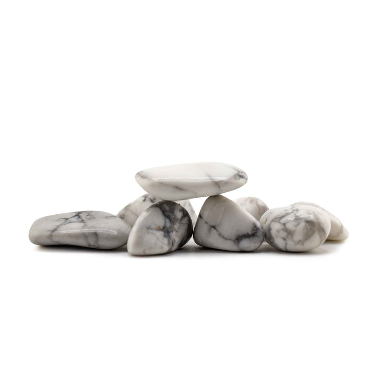 A small stack of smooth, polished gray and white howlite stone on a clean white background.