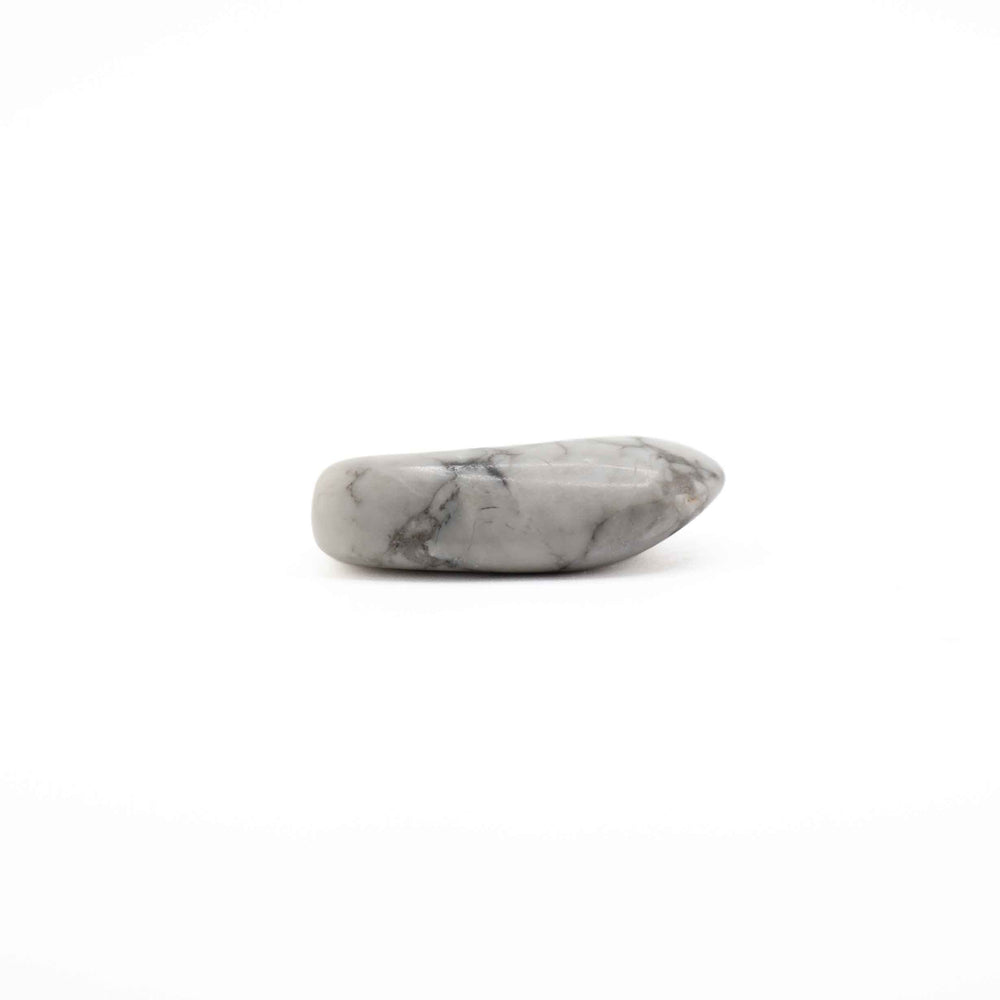 A single, elongated polished howlite tumbled stone positioned horizontally against a plain white background.