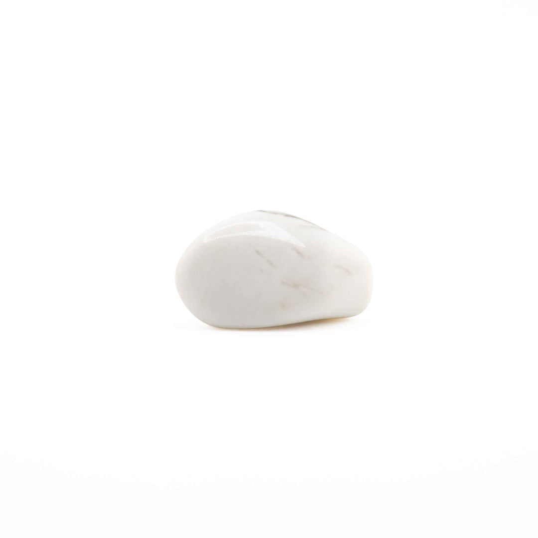 A single, smooth howlite tumbled stone with minimal veining centered on a solid white backdrop.