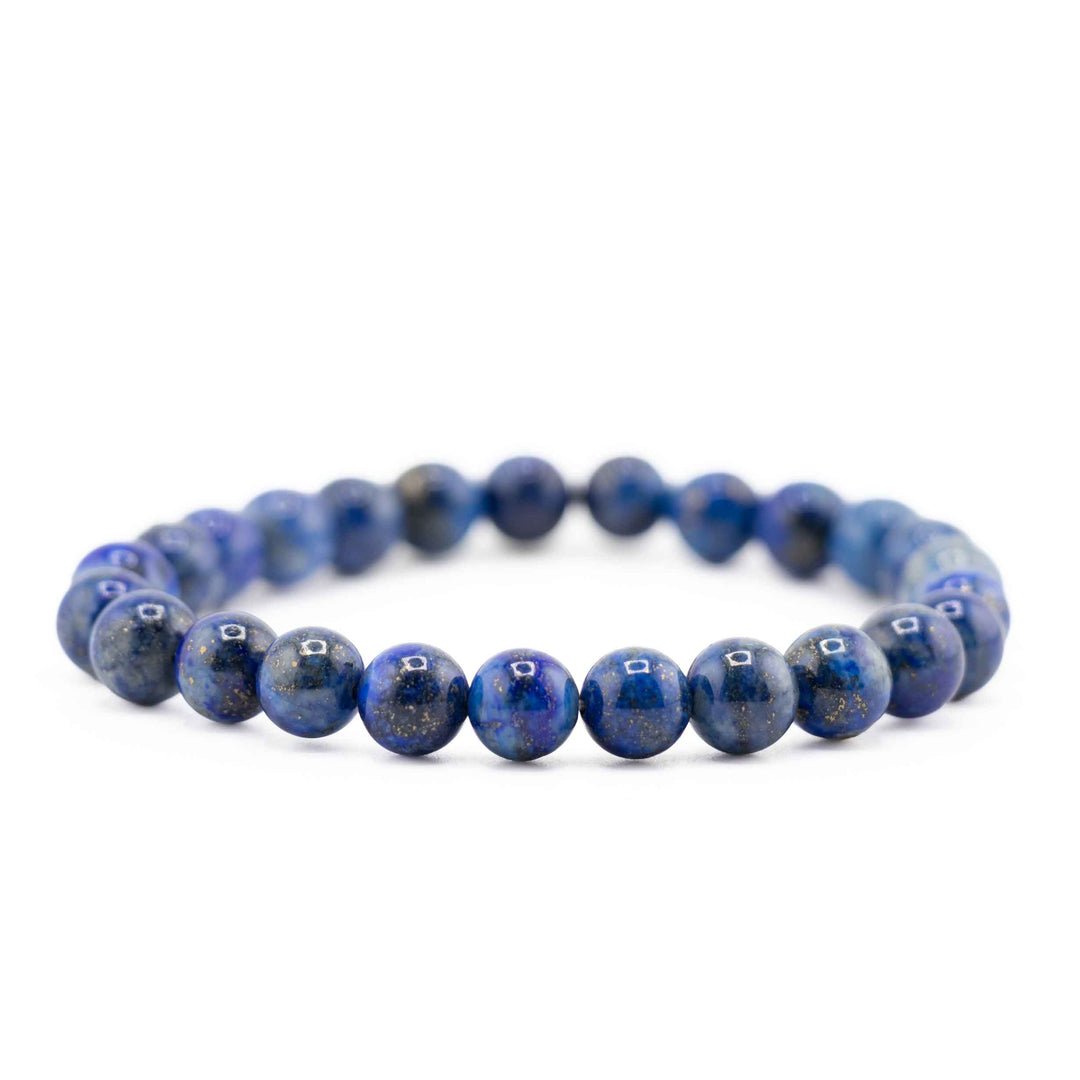 Side view resting shot of a Lapis Lazuli beaded bracelet highlighting rich deep blue stones on a white background