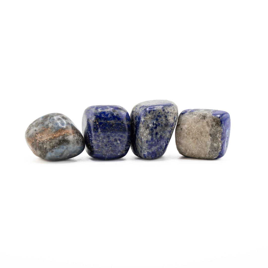 Row of four polished Lapis Lazuli tumbled stones displaying deep blue, grey matrix, and natural brown mineral inclusion variations
