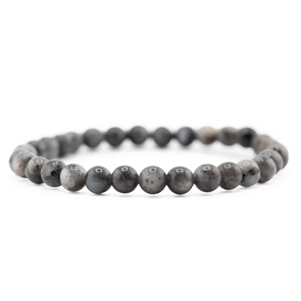 Side view resting shot of a dark grey Larvikite gemstone beaded bracelet on a white background