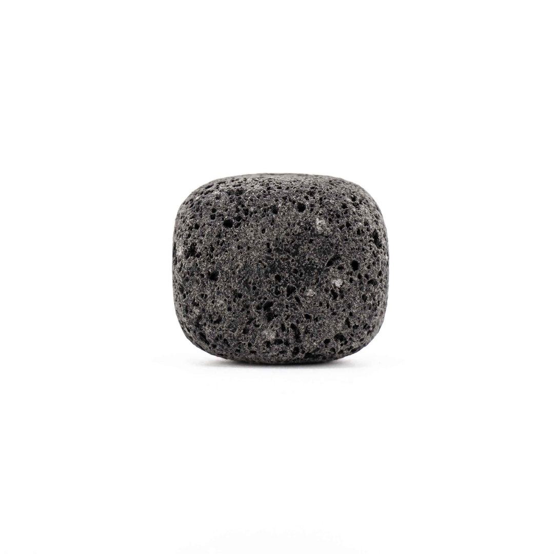 Porous black lava stone tumbled pocket stone featuring a rounded square shape and natural pitted texture