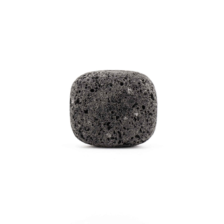 Porous black lava stone tumbled pocket stone featuring a rounded square shape and natural pitted texture