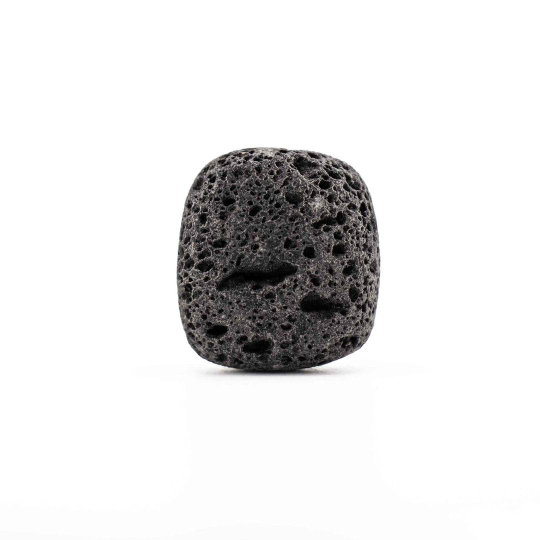 Tumbled black lava stone rock displaying prominent natural volcanic cavities and a matte finish