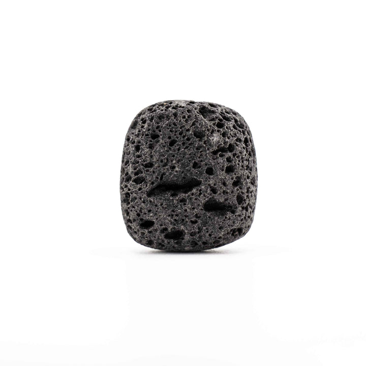 Tumbled black lava stone rock displaying prominent natural volcanic cavities and a matte finish