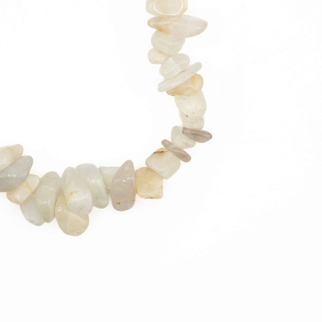 Close-up detail of polished Moonstone tumbled chips showing delicate natural variations in translucent white, cream, and soft gray