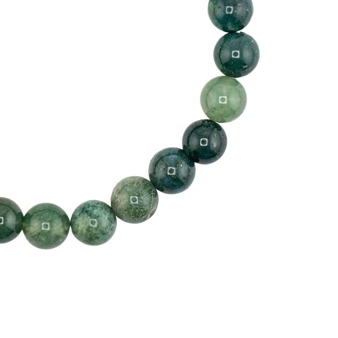 Close-up detail of smooth round Moss Agate beads showcasing deep green moss-like inclusions and natural mineral translucent variations
