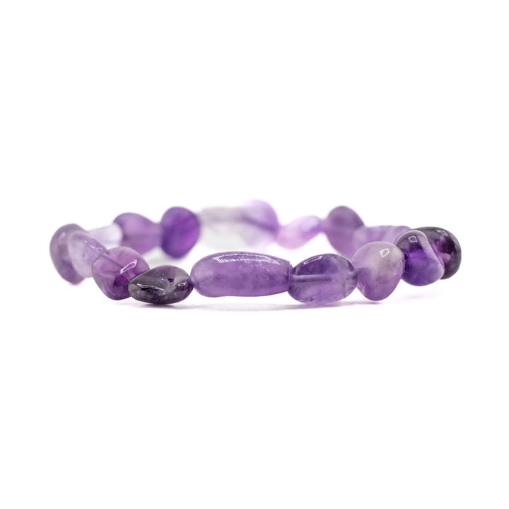 A horizontal, eye-level view of the Natural Amethyst freeform bracelet, focusing on the organic shapes and rich purple hues of the gemstone chips against a white background.