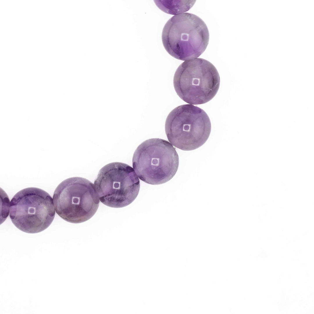 Purple beaded necklace on a white background