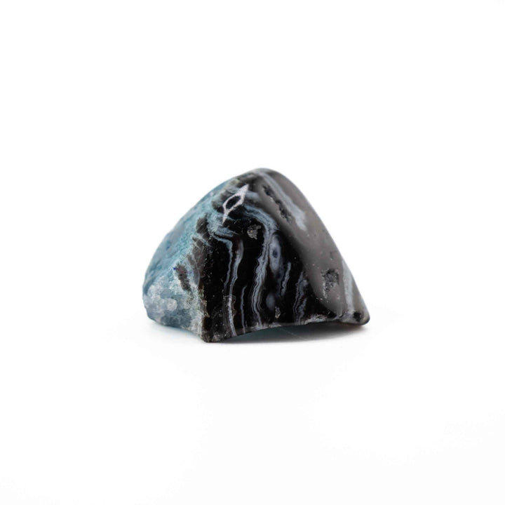 A rounded, triangular banded agate tumbled stone positioned centrally against a solid white backdrop.