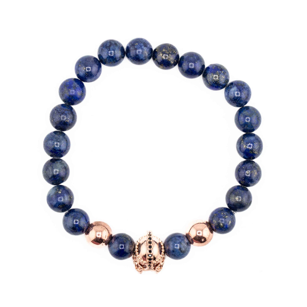 A stretch bracelet made of round, polished Lapis Lazuli beads in deep blue with a single gold-colored ancient helmet accent bead, centered on a white background.