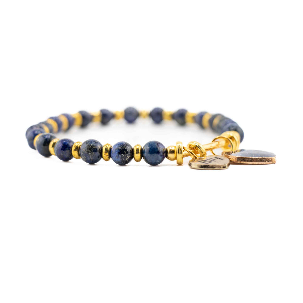 Bracelet with blue and gold beads on a white background