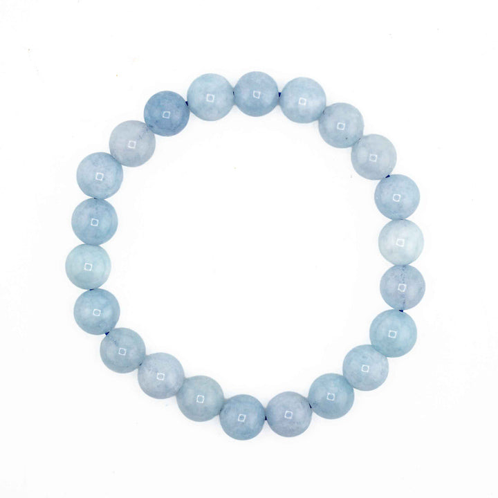 Natural Ocean Blue Aquamarine beaded stretch bracelet featuring smooth, round pale blue gemstone spheres on a white background