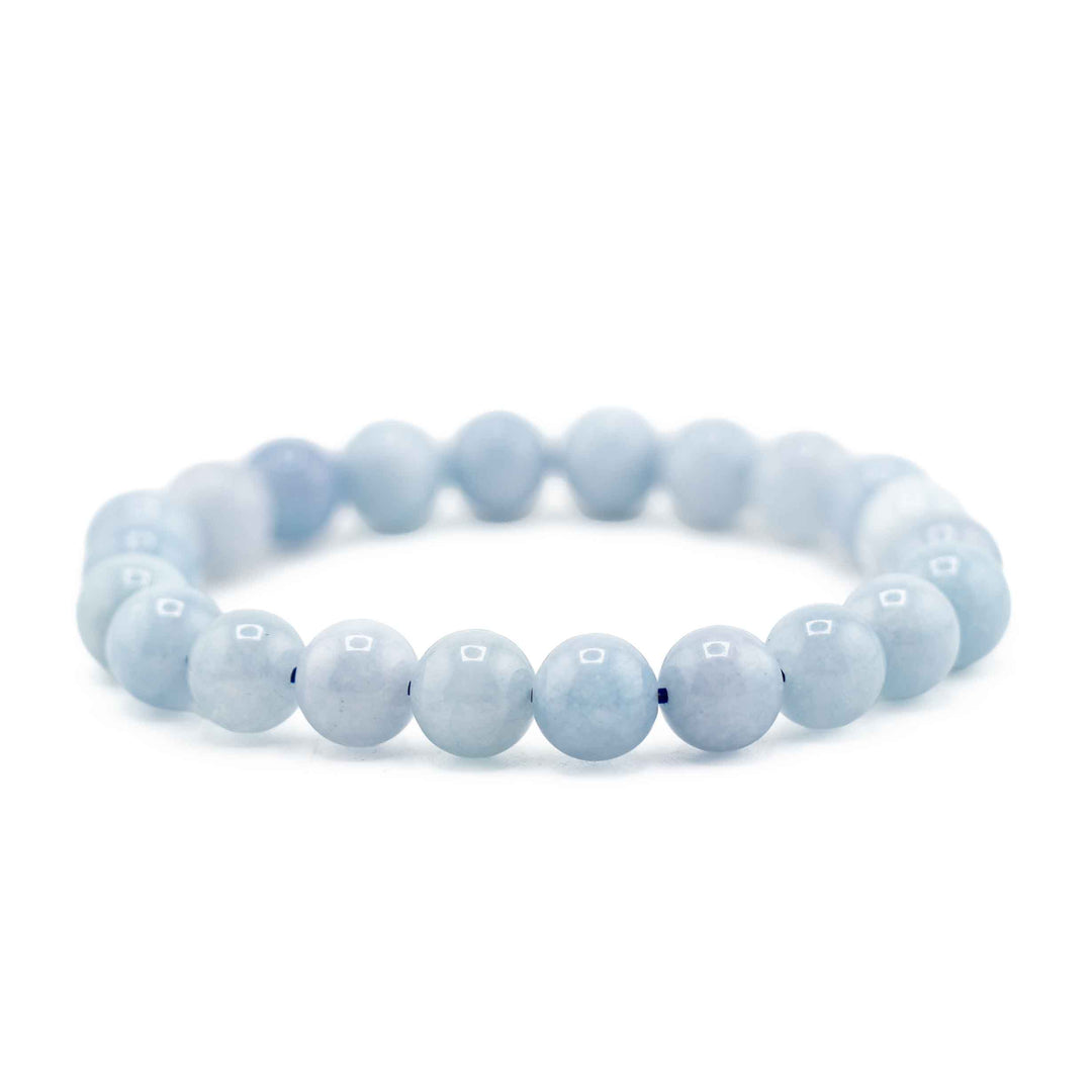 Side view resting shot of an Ocean Blue Aquamarine gemstone beaded bracelet resting flat on a white background
